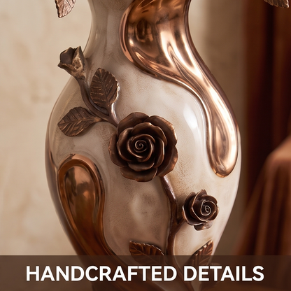 CASNELA handcrafted details — mid-body close-up showing large open rose bloom, bud, and veined leaves in antique bronze against pearl white