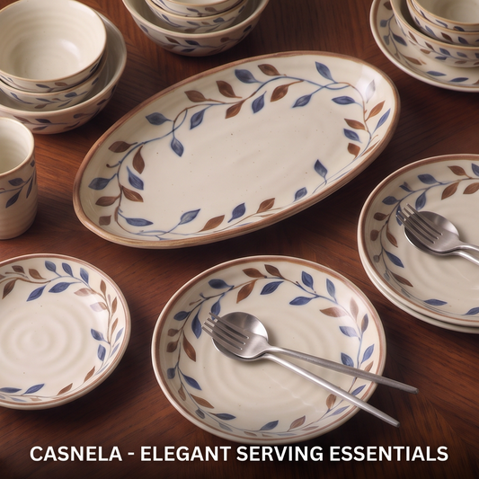 CASNELA elegant serving essentials — large oval platter, round plates and bowls overhead with silver cutlery